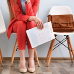 Lady sitting in a waiting area with her resume